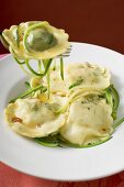 Ravioli with courgette laces on plate and fork