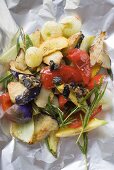 Roasted vegetables with rosemary on foil (overhead view)