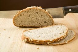 Wholemeal bread with rolled oats, partly sliced