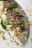Roasted gilthead bream with lemon leaves