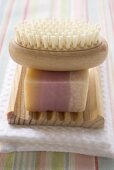 Soap and brush on wooden soap dish