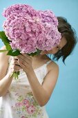 Woman holding bunch of hydrangeas