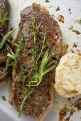 Beef steaks with herbs and garlic (overhead view)