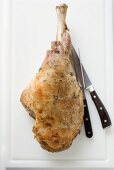 Roast turkey leg with carving knife and fork
