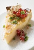 Piece of cheesecake with redcurrants