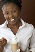 Woman holding glass of latte macchiato