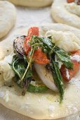 Focaccia topped with vegetables and basil