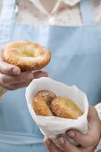 Woman holding Auszogene (Bavarian doughnuts)