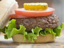 Hamburger with tomato slices and gherkin