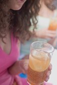 Woman holding a glass of iced tea