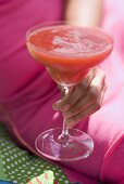 Woman holding fruity strawberry drink