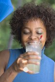 Woman drinking lemonade at a garden party