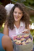 Young women with blueberry muffins on the 4th of July (USA)