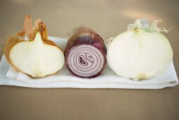Three different onions, showing cut surfaces