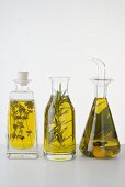 Three different herb oils in bottles standing in a row
