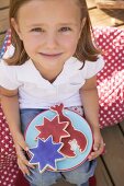 Small girl holding a plate of cookies (4th of July, USA)