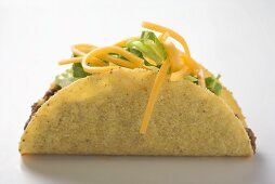Taco filled with mince, lettuce and cheese
