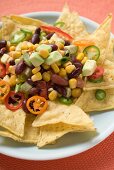 Nachos with beans, sweetcorn, avocado and chilli rings