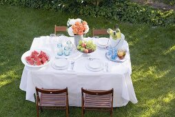 Table laid in garden for a summer party