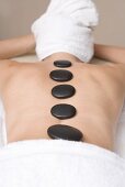 Woman having LaStone Therapy (healing therapy using stones)