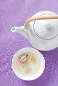 Teapot and bowl of rose tea