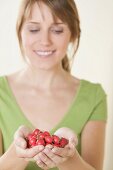 Woman holding fresh rose hips