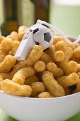 Peanut puffs with football whistle in bowl
