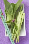 Grüner Spargel und Pak Choi mit Essstäbchen