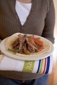 Woman holding beef tortilla