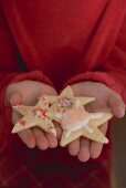 Child's hands holding Christmas biscuit