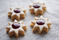 Four jam biscuits with icing sugar