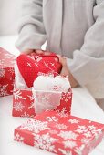 Child taking Christmas tree ornaments out of boxes