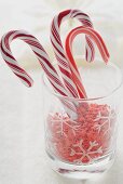 Candy canes and sugar stars in glass