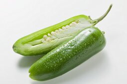 Green chilli with drops of water, halved