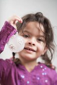 Small girl holding Christmas bauble