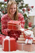 Woman looking at Christmas parcel