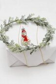 Christmas tree ornament and wreath on Christmas parcel