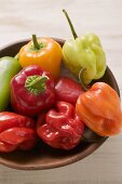 Mixed peppers and chillies in wooden dish