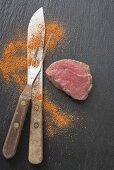 Fillet steak, carving fork, knife and spice