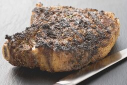 Spicy fried rib eye steak, bone-in
