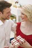 Man giving woman Christmas gift