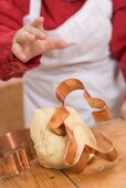 Baby reaching for gingerbread man cutter