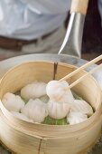 Cooking dim sum in bamboo steamer