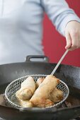 Deep-frying spring rolls in wok