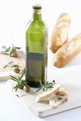 Bottle of olive oil, rosemary and bread