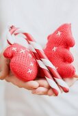 Hands holding Christmas tree ornaments