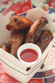 Crispy fried pork ribs with sauce to take away