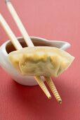 Dim sum with chopsticks and dip (Asia)