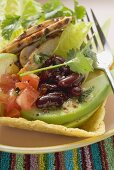 Chicken, vegetables & coriander leaves in taco shell (Mexico)