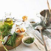 Still life with herbs, oil, onions and spices